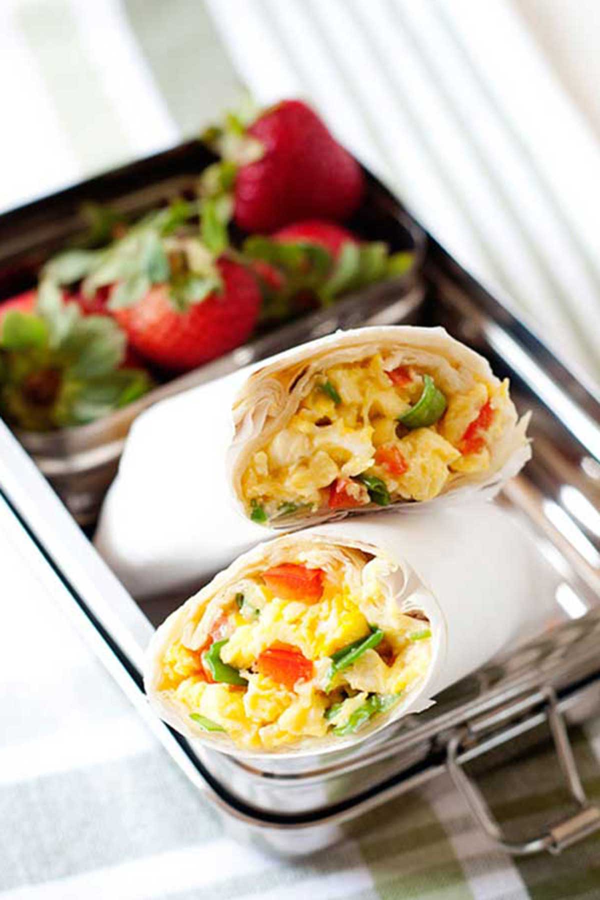 burritos de desayuno en una lonchera con frutas