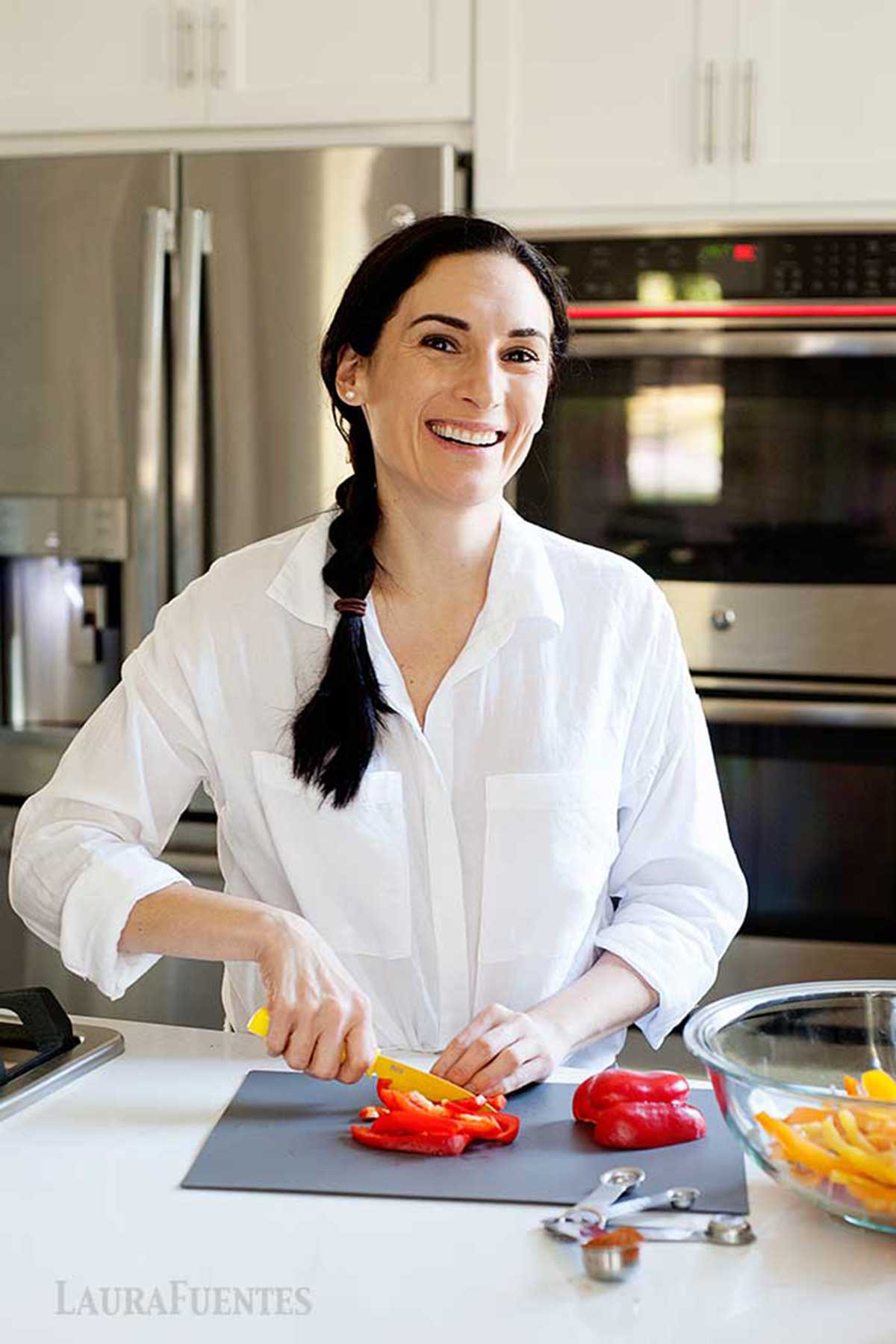 Laura in the kitchen cutting peppers