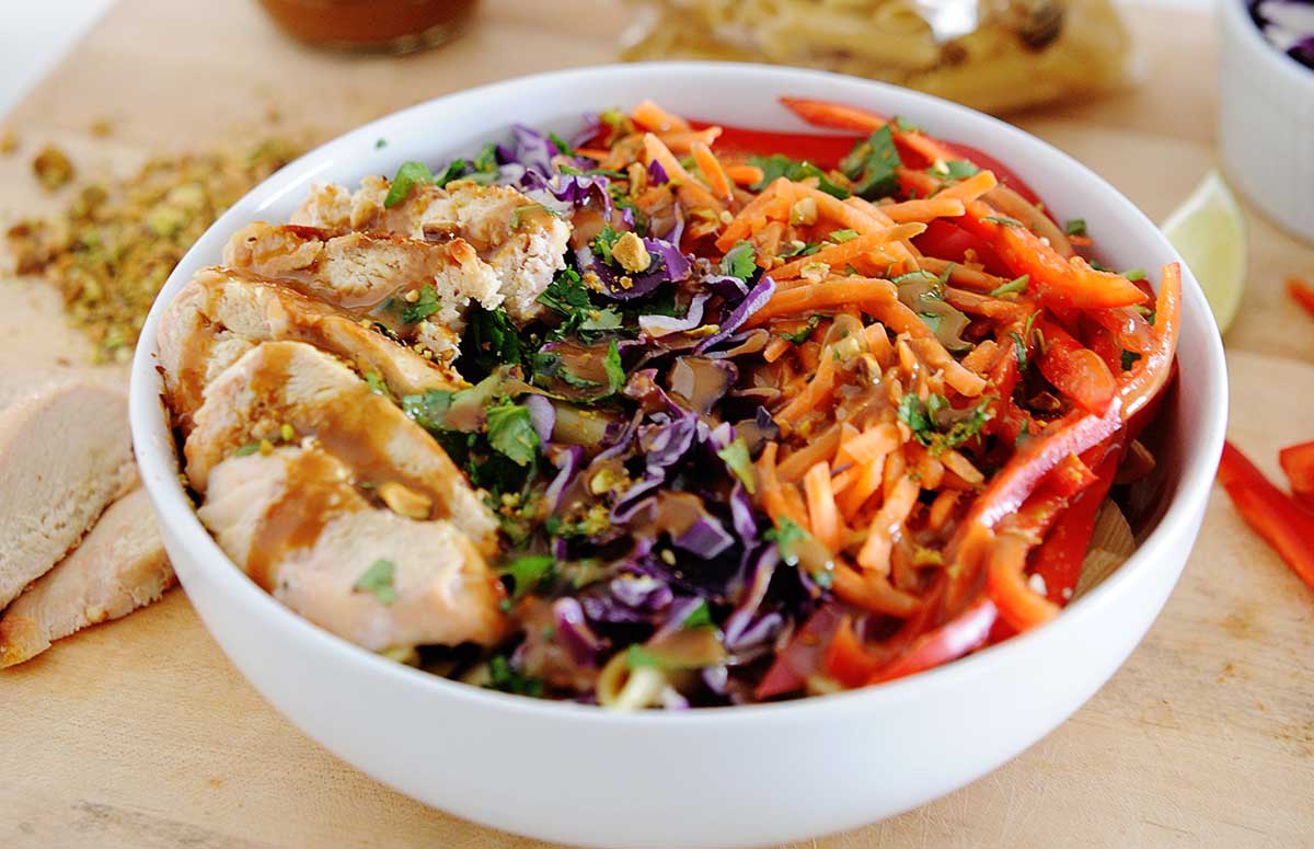 ensalada de pollo con col morada, zanahoria rallada y pimiento en tiritas