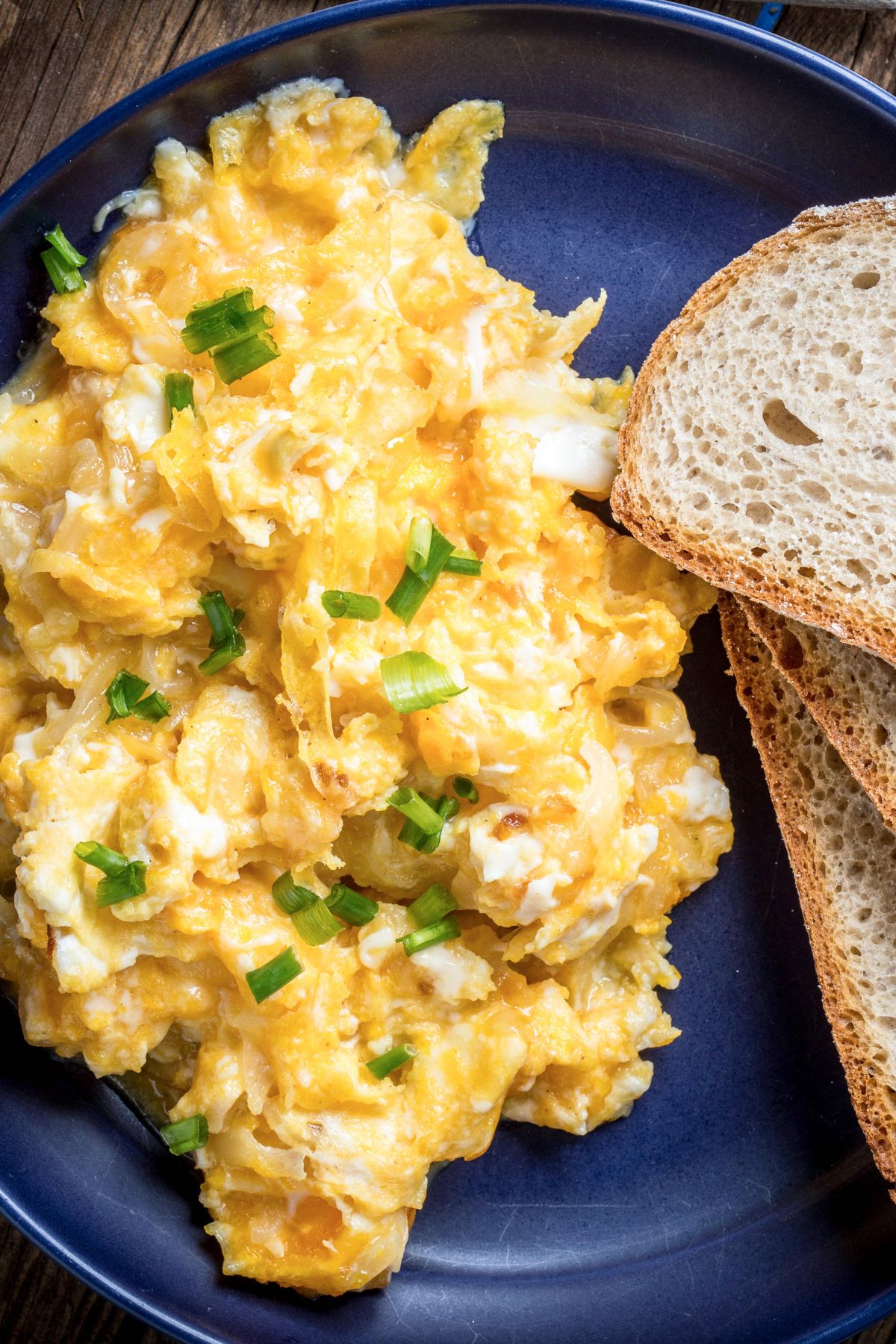 vista superior de huevos revueltos junto a unas tostadas